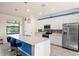 Modern kitchen with white cabinets, stainless steel appliances, and a large island at 12460 Ghiberti Cir # 202, Venice, FL 34293