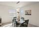 Casual dining area with wooden table and blue chairs, adjacent to kitchen at 12460 Ghiberti Cir # 202, Venice, FL 34293