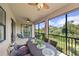 Screened-in balcony with outdoor furniture and tranquil view at 12460 Ghiberti Cir # 202, Venice, FL 34293