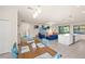 Bright dining room with a wooden table and blue chairs, near the kitchen at 12460 Ghiberti Cir # 202, Venice, FL 34293