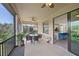 Outdoor patio with table and chairs; view of kitchen at 12460 Ghiberti Cir # 202, Venice, FL 34293