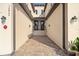 Shared entry to a two-story townhome with brick walkway and lighting at 12460 Ghiberti Cir # 202, Venice, FL 34293