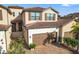 Two-story townhome with a two-car garage and brick driveway at 12460 Ghiberti Cir # 202, Venice, FL 34293