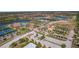 Aerial view of community with pool, tennis courts, and homes at 12460 Ghiberti Cir # 202, Venice, FL 34293