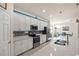 Modern kitchen with stainless steel appliances, white cabinets, and a large island at 12460 Ghiberti Cir # 202, Venice, FL 34293