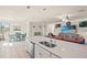 Open concept kitchen with large island, stainless steel appliances, and white cabinetry at 12460 Ghiberti Cir # 202, Venice, FL 34293