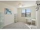 Bright bedroom featuring a desk, chair, shelving, and large window at 12460 Ghiberti Cir # 202, Venice, FL 34293