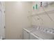 Laundry room with washer, dryer, and wire shelving for storage at 12460 Ghiberti Cir # 202, Venice, FL 34293