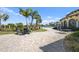 Relaxing pool area with patio furniture and beautiful landscaping at 12460 Ghiberti Cir # 202, Venice, FL 34293
