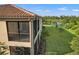 Property exterior showcasing a screened balcony and lake view at 12460 Ghiberti Cir # 202, Venice, FL 34293