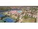 Aerial view of community pool, tennis courts, and clubhouse at 12460 Ghiberti Cir # 202, Venice, FL 34293