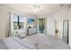 Main bedroom with king bed, balcony access, and ensuite bath at 12460 Ghiberti Cir # 202, Venice, FL 34293