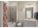Clean bathroom with a tub shower, white vanity, and decorative shower curtain at 12460 Ghiberti Cir # 202, Venice, FL 34293