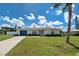 Well maintained home with a blue garage door and lush lawn at 511 Porpoise Rd, Venice, FL 34293