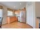 Kitchen with stainless steel appliances and wood cabinets at 511 Porpoise Rd, Venice, FL 34293