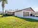 Tan two-car garage, attached home with well maintained lawn at 401 Curry St # 66, North Venice, FL 34275