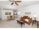 Open living and dining area with a brown couch and glass-top coffee table at 401 Curry St # 66, North Venice, FL 34275