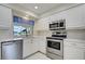 Kitchen with stainless steel appliances and white cabinets at 466 Lake Of The Woods Dr, Venice, FL 34293