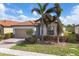 Single-story home with tan colored exterior and palm trees at 10135 Crooked Creek Dr, Venice, FL 34293