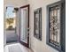 Front entry with decorative wall hangings and view of the front door at 10135 Crooked Creek Dr, Venice, FL 34293