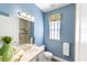 Bathroom with single vanity, light blue walls, and a shower/tub combo at 10301 Crooked Creek Dr, Venice, FL 34293