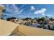 Community view from a private balcony, overlooking houses and palm trees at 1152 Beachcomber Ct # 15, Osprey, FL 34229