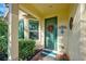 Quaint front entrance with a green door and seasonal wreath at 1152 Beachcomber Ct # 15, Osprey, FL 34229