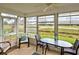 Bright sunroom with table and chairs, overlooking the golf course at 1342 Capri Isles Blvd # 14, Venice, FL 34292