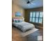 Cozy bedroom featuring neutral paint, plantation shutters, and tile flooring, virtually staged with modern furniture at 217 Carriage House Ln # 217, Nokomis, FL 34275