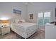 Comfortable bedroom with a beach-themed decor, shuttered window, and tile floors at 217 Carriage House Ln # 217, Nokomis, FL 34275