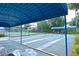 View of the bocce ball court, covered area, seating, and greenery surrounding the area at 217 Carriage House Ln # 217, Nokomis, FL 34275