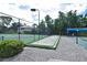 View of the bocce ball court, surrounding greenery, and neighborhood homes in the background at 217 Carriage House Ln # 217, Nokomis, FL 34275