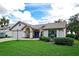 Charming single-story home with a tile roof, well-manicured lawn, and beautiful landscaping at 217 Carriage House Ln # 217, Nokomis, FL 34275