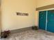 Inviting entryway showcasing a blue double-door, decorative 'Welcome' sign, and stylish brick flooring at 217 Carriage House Ln # 217, Nokomis, FL 34275