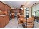 Eat-in kitchen area features wooden cabinets, mosaic backsplash, and stainless steel appliances at 217 Carriage House Ln # 217, Nokomis, FL 34275