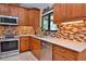Updated kitchen features granite countertops, tile backsplash, and stainless steel appliances at 217 Carriage House Ln # 217, Nokomis, FL 34275