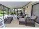 Relaxing screened lanai with comfortable seating, coffee table, and tranquil outdoor views at 217 Carriage House Ln # 217, Nokomis, FL 34275