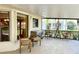 Covered lanai featuring an outdoor kitchen, chairs, and peaceful views of the surroundings at 217 Carriage House Ln # 217, Nokomis, FL 34275
