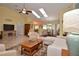 Bright living room with vaulted ceilings, skylights, neutral decor, and an open floor plan to the dining area at 217 Carriage House Ln # 217, Nokomis, FL 34275