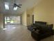 Bright living room with high ceilings, tile flooring, and access to the outdoor pool area at 217 Carriage House Ln # 217, Nokomis, FL 34275