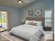 Bright bedroom with a ceiling fan, a sliding glass door, neutral tones, and plantation shutters at 217 Carriage House Ln # 217, Nokomis, FL 34275