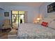 Bedroom with sliding door access to a screened lanai at 217 Carriage House Ln # 217, Nokomis, FL 34275