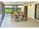 Covered patio with a wooden table and chairs perfect for outdoor dining at 217 Carriage House Ln # 217, Nokomis, FL 34275