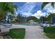 Community pool and recreation area featuring ample seating and lush tropical landscaping at 217 Carriage House Ln # 217, Nokomis, FL 34275