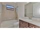 Clean bathroom with a tub, toilet, and vanity with quartz countertop at 25134 Spartina Dr, Venice, FL 34293