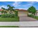 Single-Gathering home with orange tile roof and landscaping at 25134 Spartina Dr, Venice, FL 34293