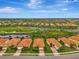 Community view of houses near a golf course and lake at 25134 Spartina Dr, Venice, FL 34293