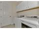 Laundry room with washer, dryer, and cabinets at 25134 Spartina Dr, Venice, FL 34293