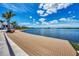 Relaxing boardwalk with lake views and red Adirondack chairs at 25134 Spartina Dr, Venice, FL 34293