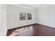 Bright bedroom with dark hardwood floors and large window at 329 Savona Way, North Venice, FL 34275